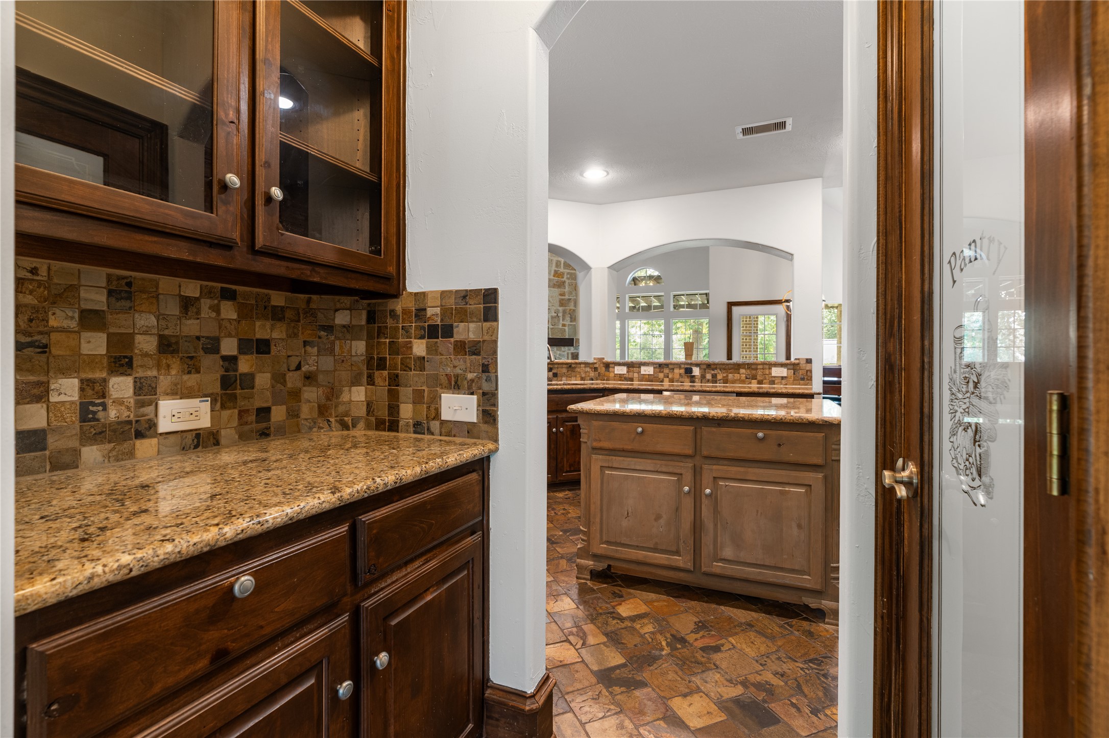 2115 Graystone Ridge Drive Conroe, TX 77304 - Photo 9 of 47 Butler’s pantry and large walk-in pantry offer abundant storage and convenient access to the kitchen.
