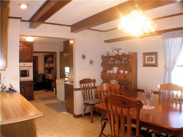 1077 Liberty Road Winchester, TN 37398 - Photo 11 of 20 Breakfast nook has vinyl flooring, exposed beams, pantry, and eat at bar.