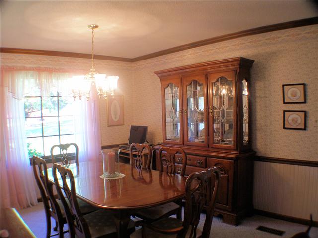 1077 Liberty Road Winchester, TN 37398 - Photo 12 of 20 Dining room has carpet, crown molding, chair rail and a picturesque window.
