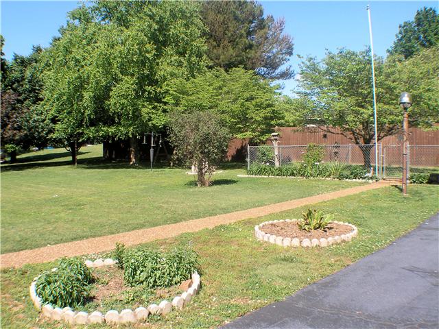1077 Liberty Road Winchester, TN 37398 - Photo 3 of 20 Nice yard all around home with fenced area by detached garage and privacy fence along back property line.