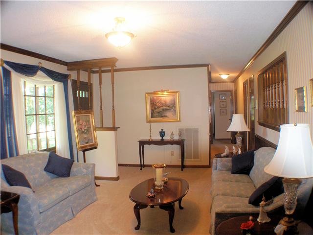 1077 Liberty Road Winchester, TN 37398 - Photo 7 of 20 Living room has carpet, crown molding, and entry foyer.