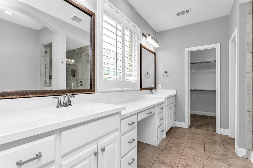 15713 Canyon Ridge Prosper, TX 75078 - Photo 23 of 38 Dual vanity with white cabinetry and integrated sinks, complemented by chrome fixtures