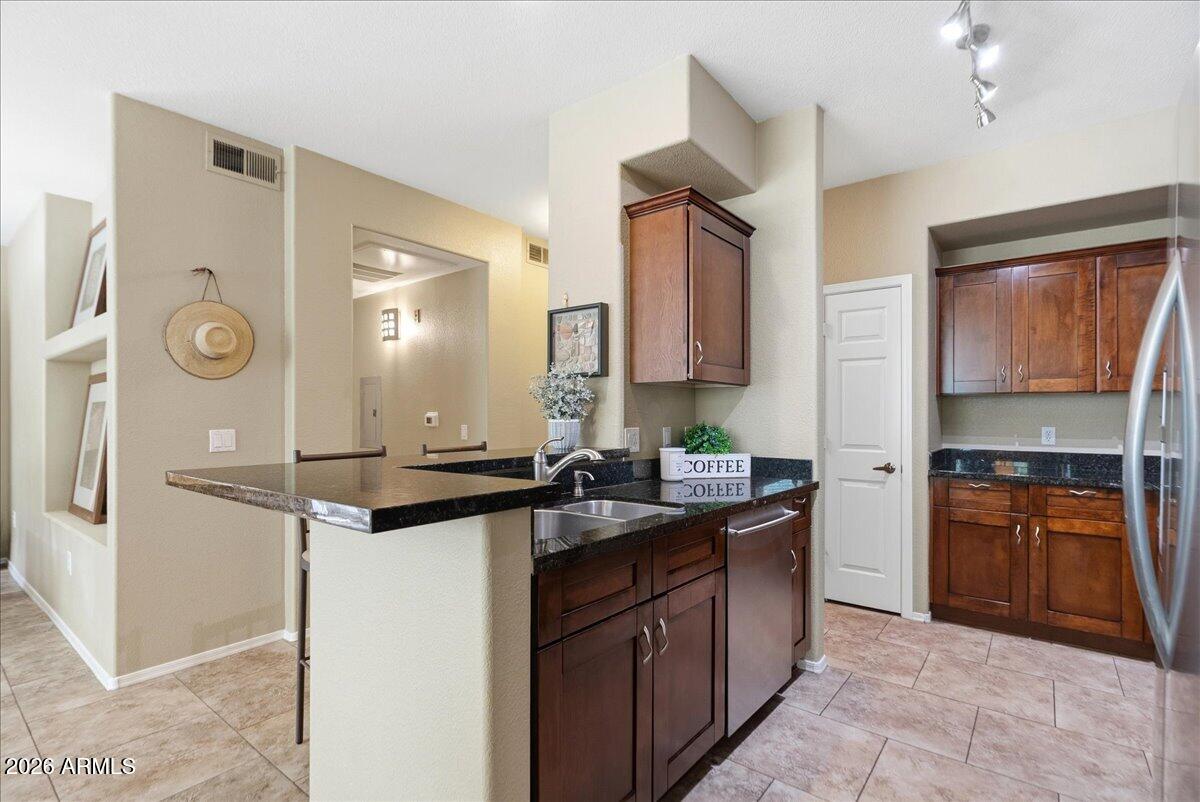 435 West Rio Salado Parkway, Unit 111 Tempe, AZ 85281 - Photo 10 of 44 a kitchen with stainless steel appliances granite countertop a sink stove and refrigerator