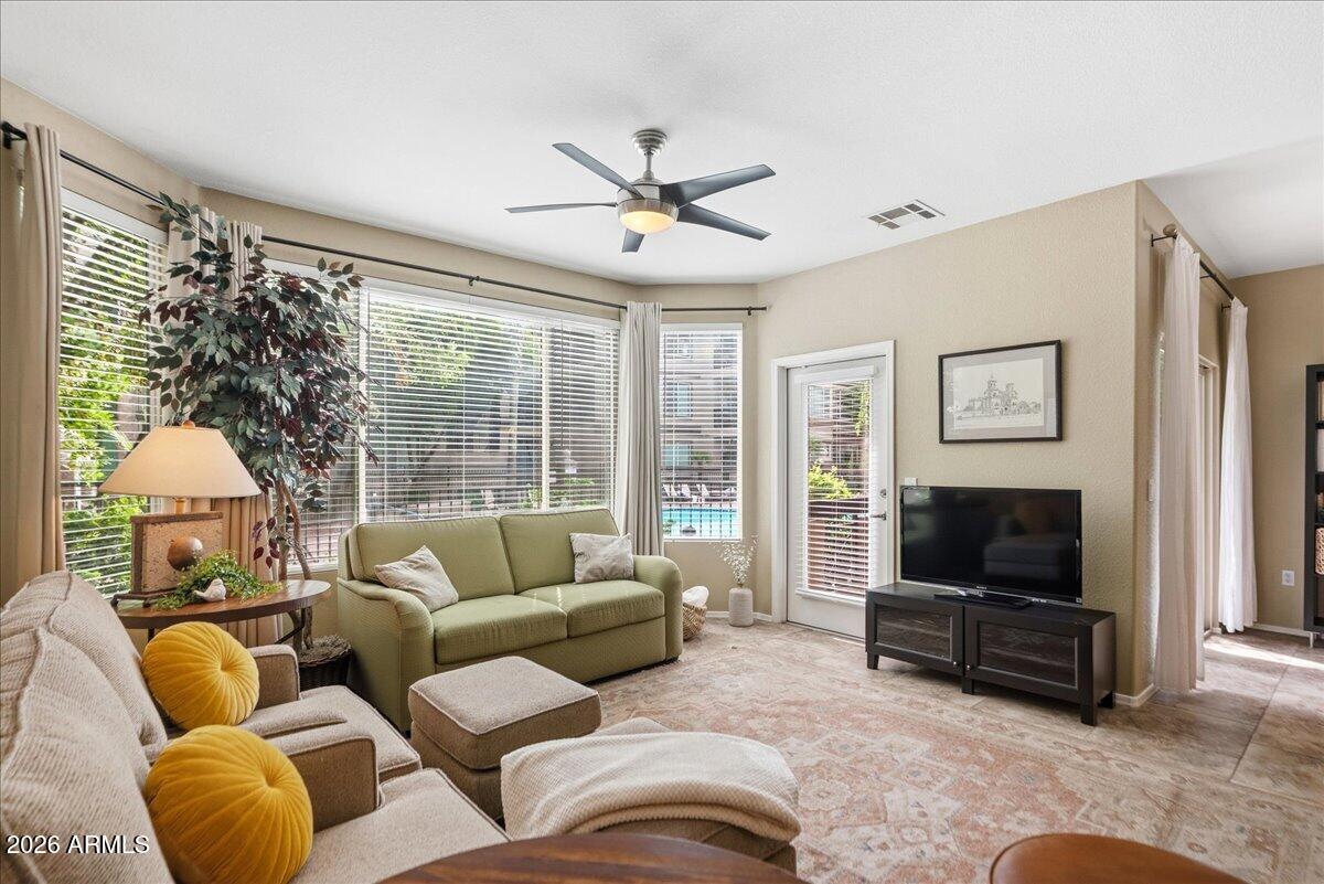 435 West Rio Salado Parkway, Unit 111 Tempe, AZ 85281 - Photo 12 of 44 a living room with furniture a flat screen tv and a large window