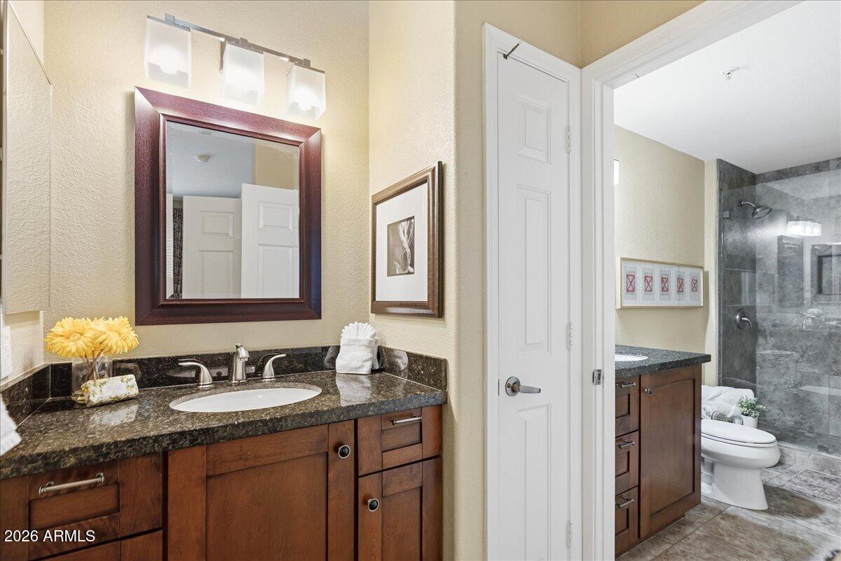 435 West Rio Salado Parkway, Unit 111 Tempe, AZ 85281 - Photo 27 of 44 a bathroom with a granite countertop sink toilet and mirror