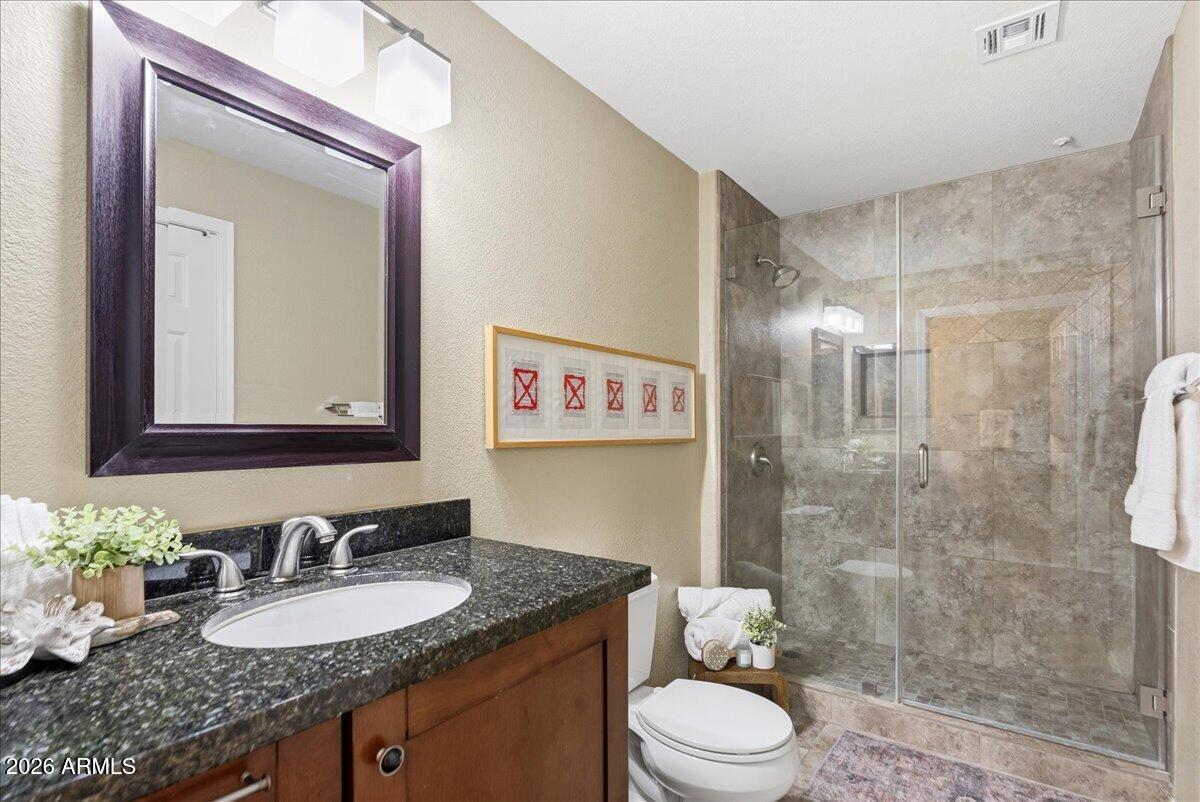435 West Rio Salado Parkway, Unit 111 Tempe, AZ 85281 - Photo 28 of 44 a bathroom with a granite countertop sink toilet a mirror and shower