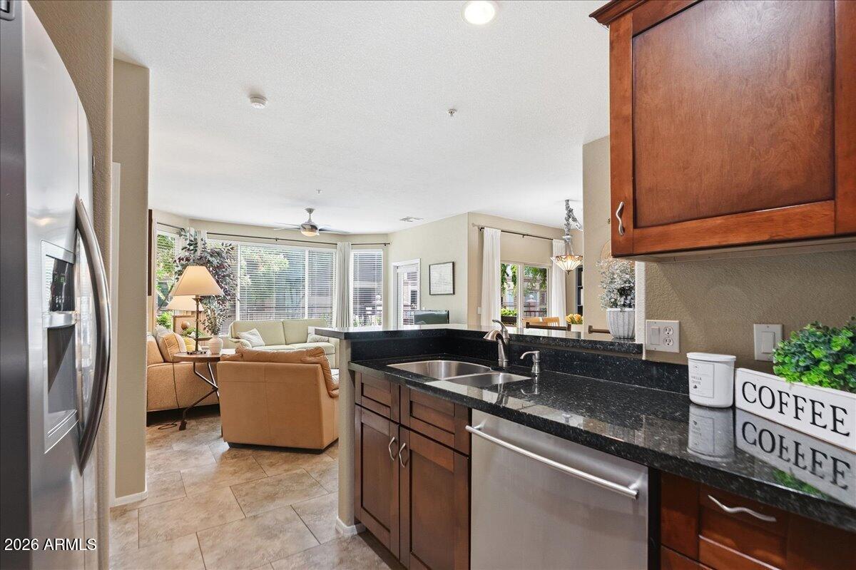 435 West Rio Salado Parkway, Unit 111 Tempe, AZ 85281 - Photo 2 of 44 a kitchen with granite countertop a sink and a refrigerator