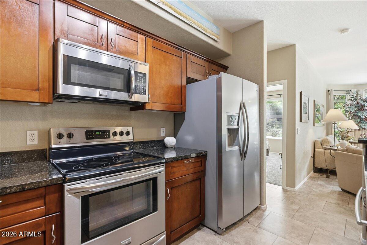 435 West Rio Salado Parkway, Unit 111 Tempe, AZ 85281 - Photo 9 of 44 a kitchen with stainless steel appliances granite countertop a stove a refrigerator and a microwave