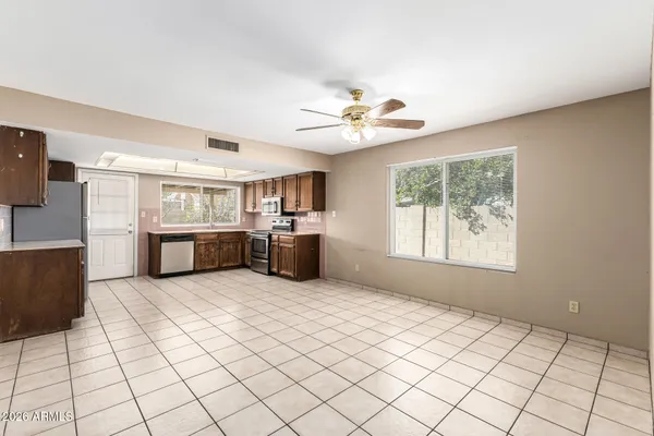 a large white kitchen with a large window