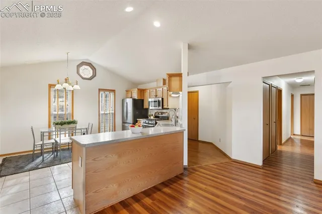 a large kitchen with a table and chairs