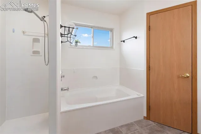 a white bath tub sitting next to a shower