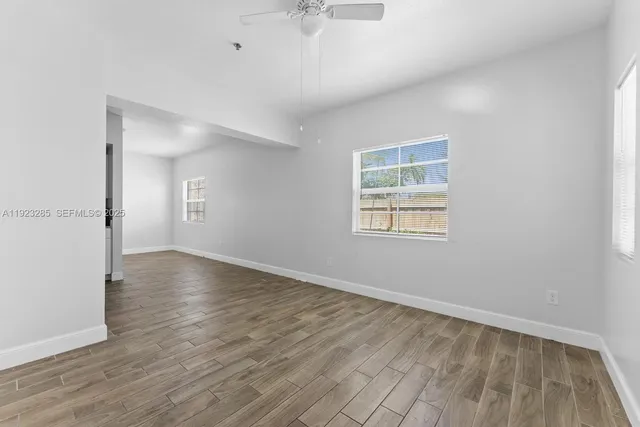 wooden floor in an empty room with a window