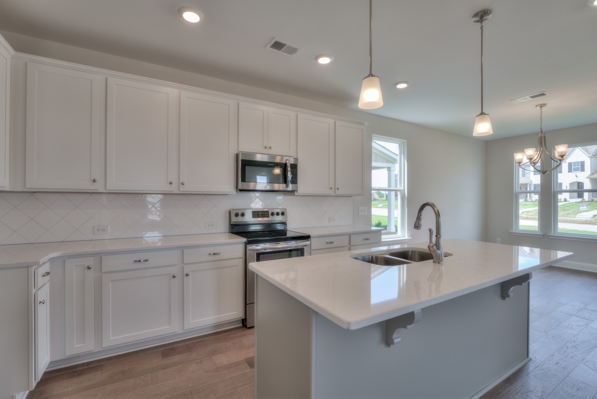 9012 Headwaters Drive Franklin, TN 37064 - Photo 10 of 25 a kitchen with kitchen island white cabinets appliances and a sink