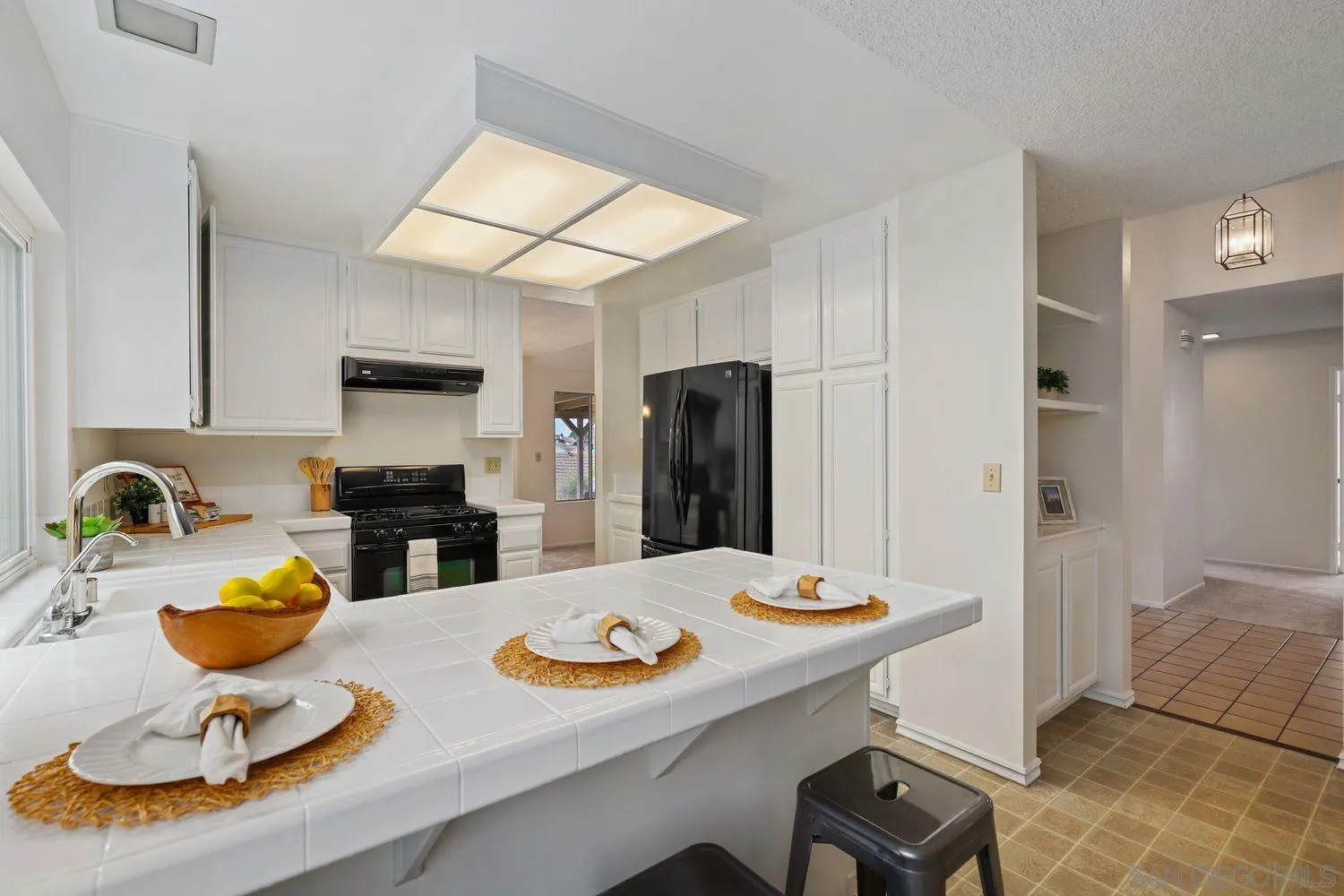 7912 Hemphill Drive San Diego, CA 92126 - Photo 11 of 17 a kitchen with sink refrigerator dining table and chairs