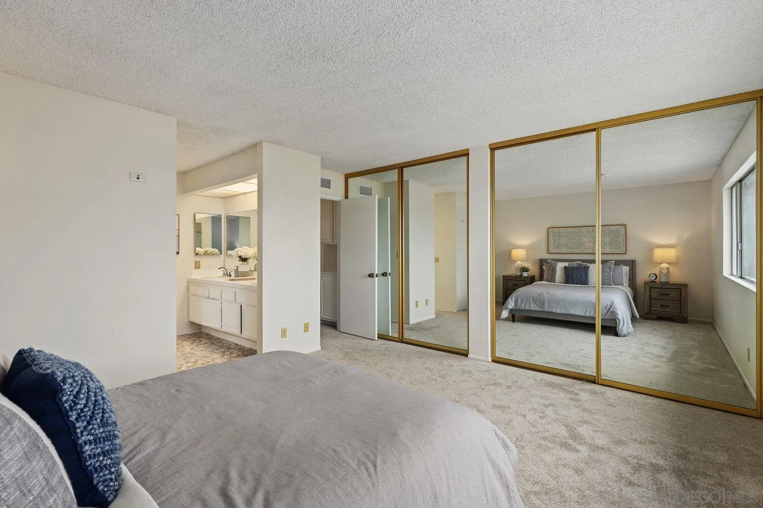 7912 Hemphill Drive San Diego, CA 92126 - Photo 13 of 17 a bedroom with a bed and a mirror