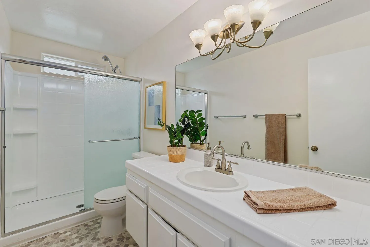 7912 Hemphill Drive San Diego, CA 92126 - Photo 16 of 17 a bathroom with a sink a toilet and shower