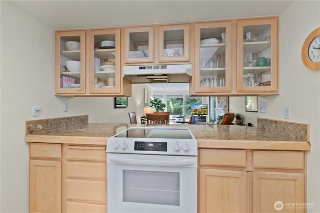 a kitchen with a stove cabinets and a sink