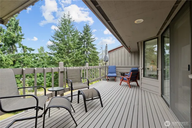 a view of a patio with table and chairs and wooden floor