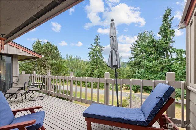 a view of a balcony with wooden floor and outdoor seating