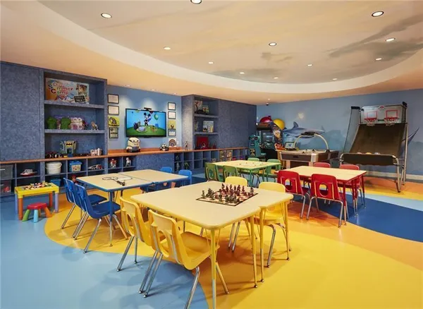 a dining hall with lots of wooden furniture and large windows