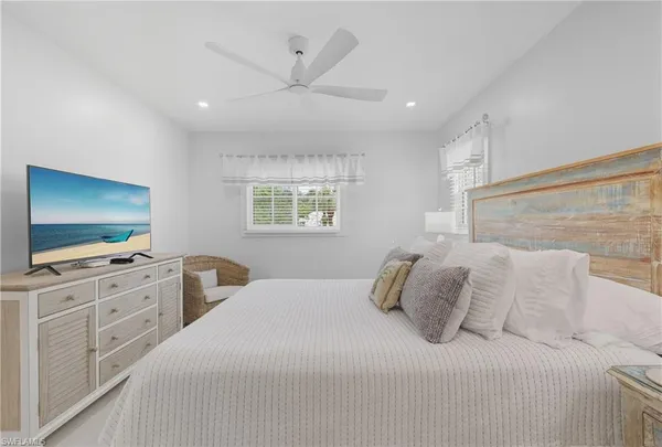 a bedroom with a large bed and a flat screen tv