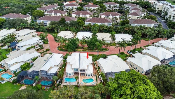 an aerial view of residential houses with outdoor space and street view
