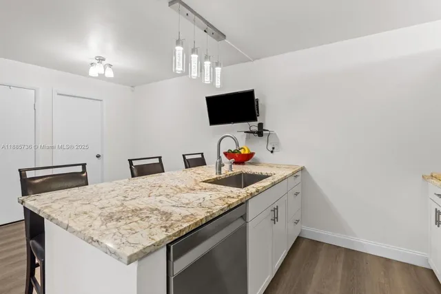 a kitchen with a sink and a refrigerator