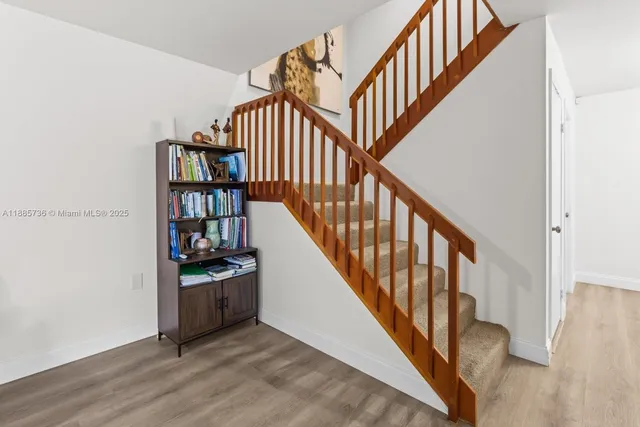 a view of staircase with wooden floor and stairs