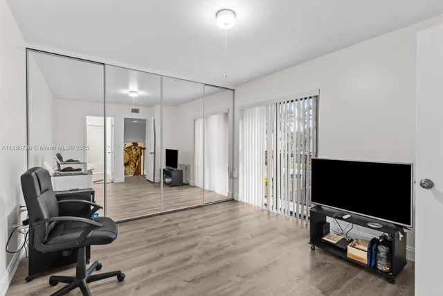 a view of a livingroom with entryway and furniture