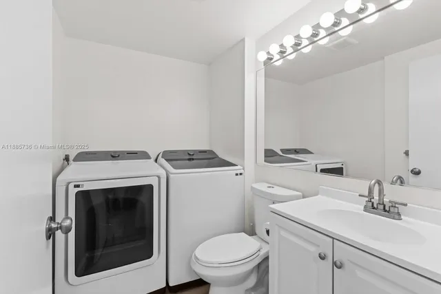 a view of bathroom with a washer and dryer