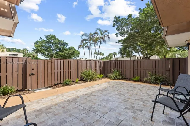 a backyard of a house with table and chairs