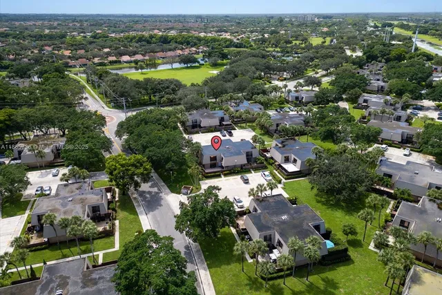 an aerial view of residential houses with outdoor space