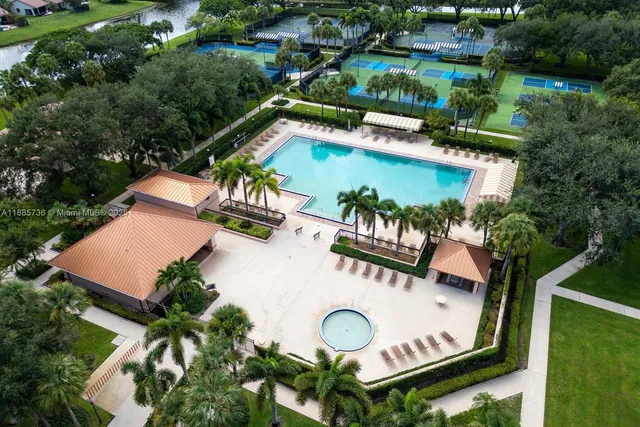 an aerial view of a swimming pool patio and outdoor seating