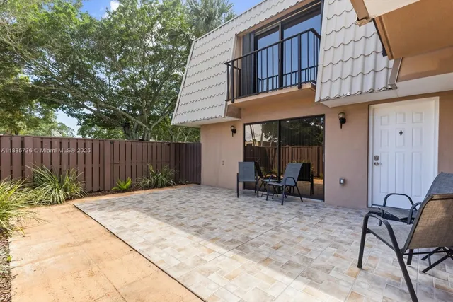 a view of a house with backyard and sitting area