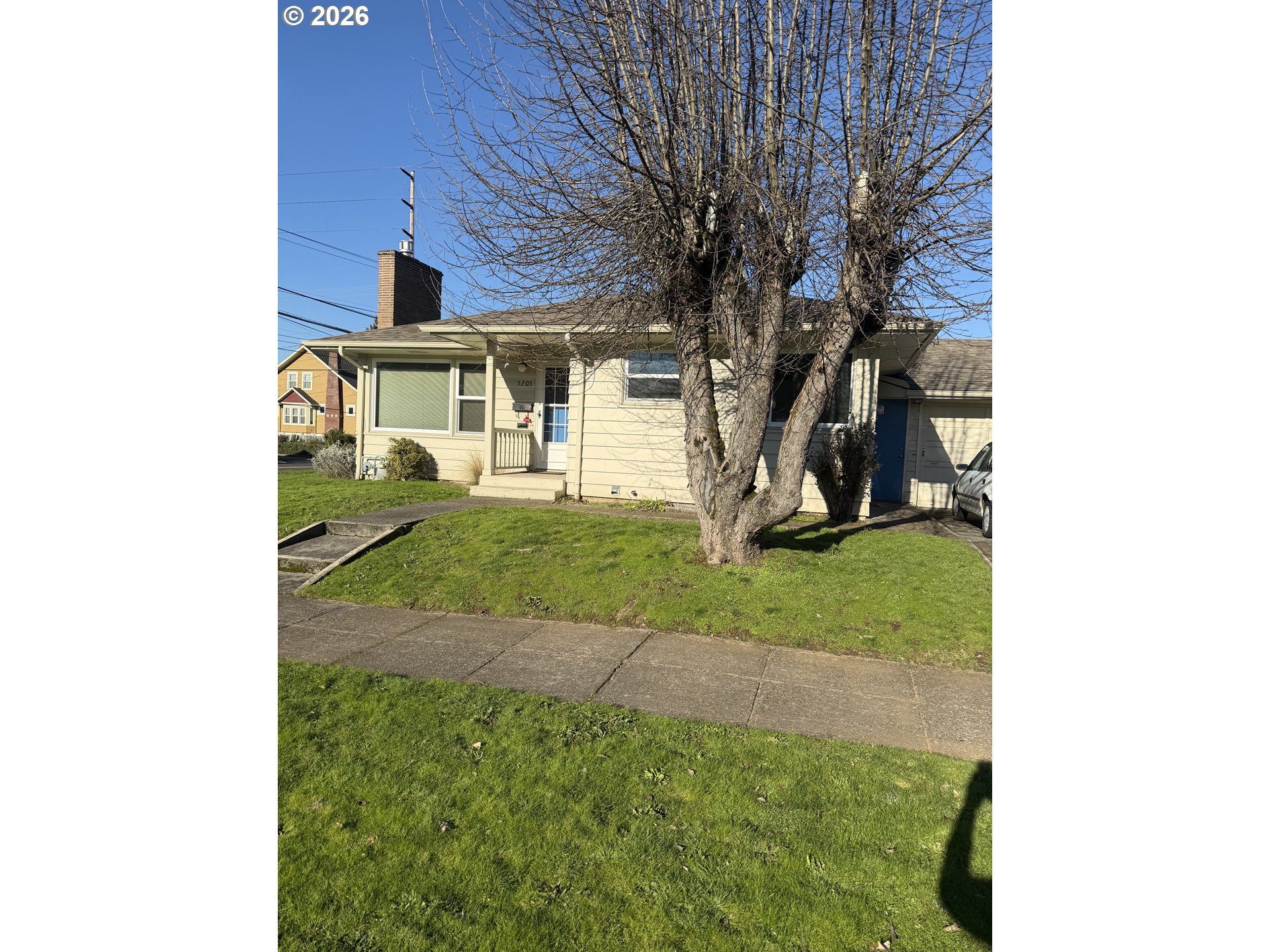 5205 Southeast Ramona Street Portland, OR 97206 - Photo 2 of 10 a front view of a house with a yard