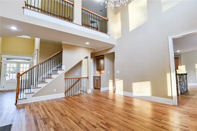 a large kitchen with stainless steel appliances granite countertop a large counter top a stove a sink and a refrigerator