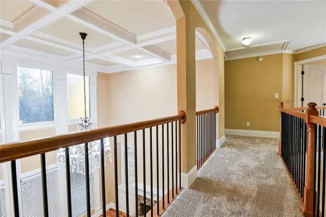 an empty room with a ceiling fan and carpet