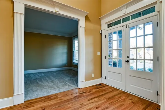 a view of empty room with window and wooden floor