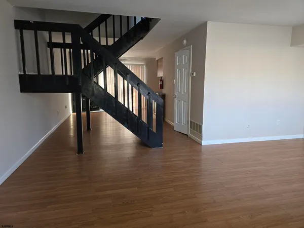 a view of an empty room with a fireplace and a window