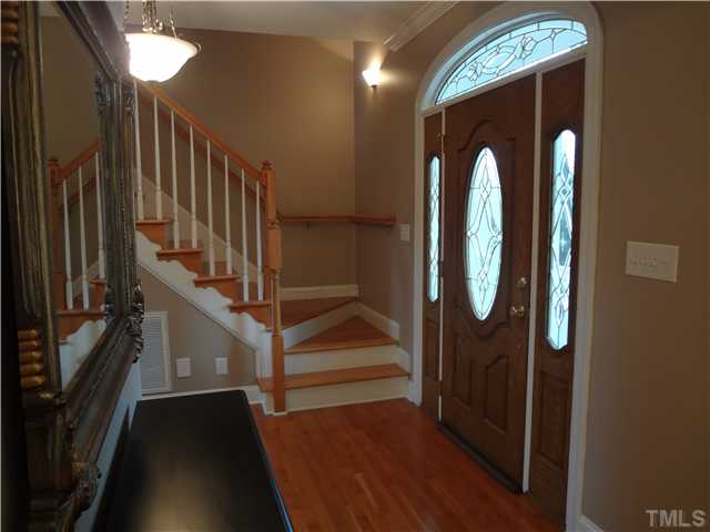 3632 Range Road Stem, NC 27581 - Photo 4 of 25 Foyer has site finished hardwood floors and open railing staircase.