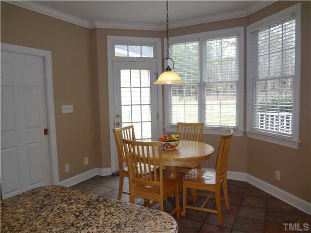 3632 Range Road Stem, NC 27581 - Photo 9 of 25 Tile floors, bay window breakfast area and 15 lite door w/transom to deck. Pocket door to utility.