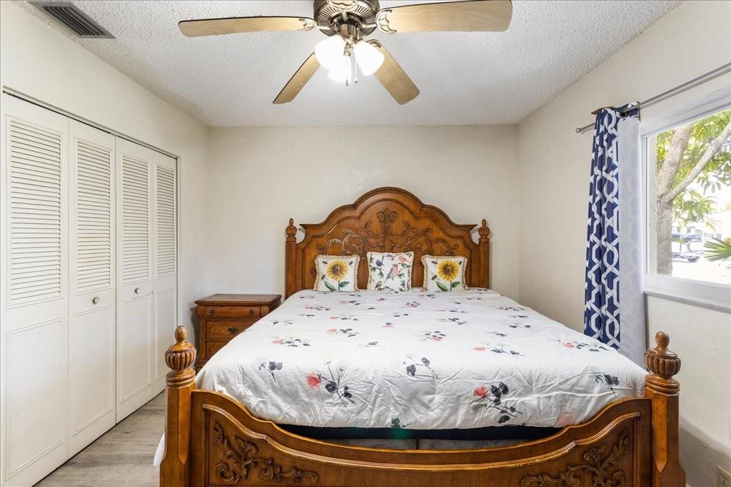 6800 Northwest 75th Drive Tamarac, FL 33321 - Photo 13 of 20 a bedroom with a bed and a chandelier