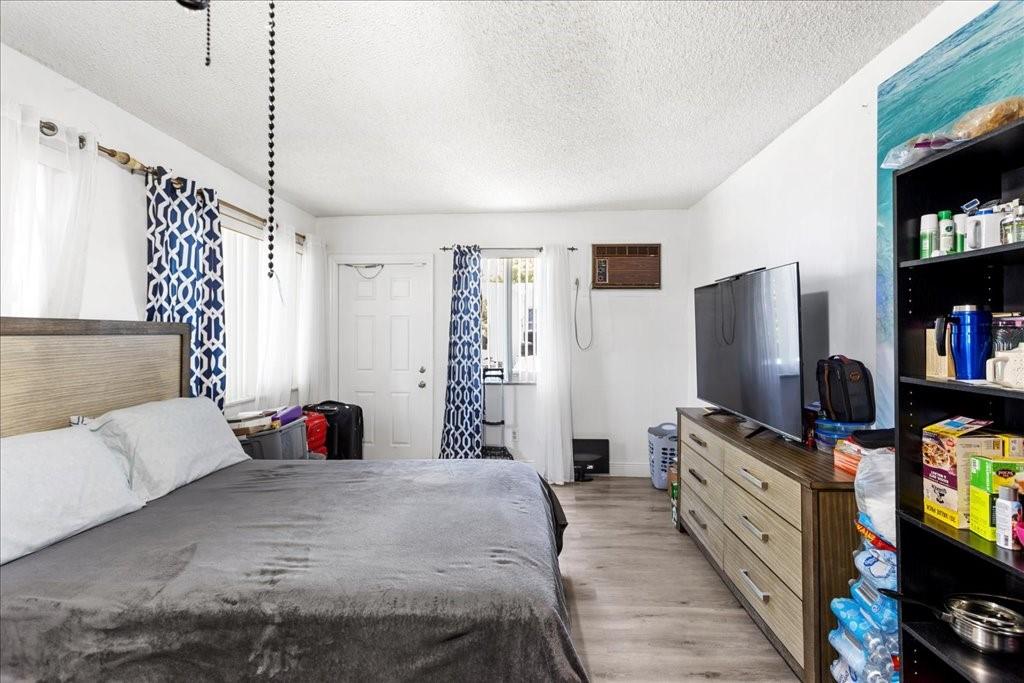 6800 Northwest 75th Drive Tamarac, FL 33321 - Photo 17 of 20 a bedroom with a bed and a flat screen tv