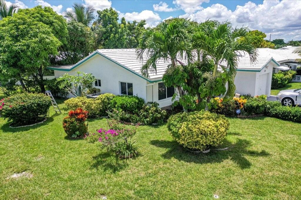 6800 Northwest 75th Drive Tamarac, FL 33321 - Photo 3 of 20 a view of a house with a yard and garden