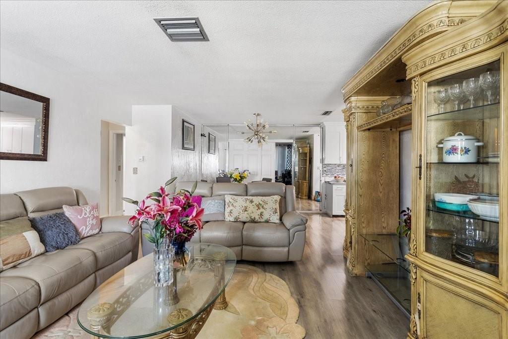 6800 Northwest 75th Drive Tamarac, FL 33321 - Photo 4 of 20 a living room with furniture and a chandelier