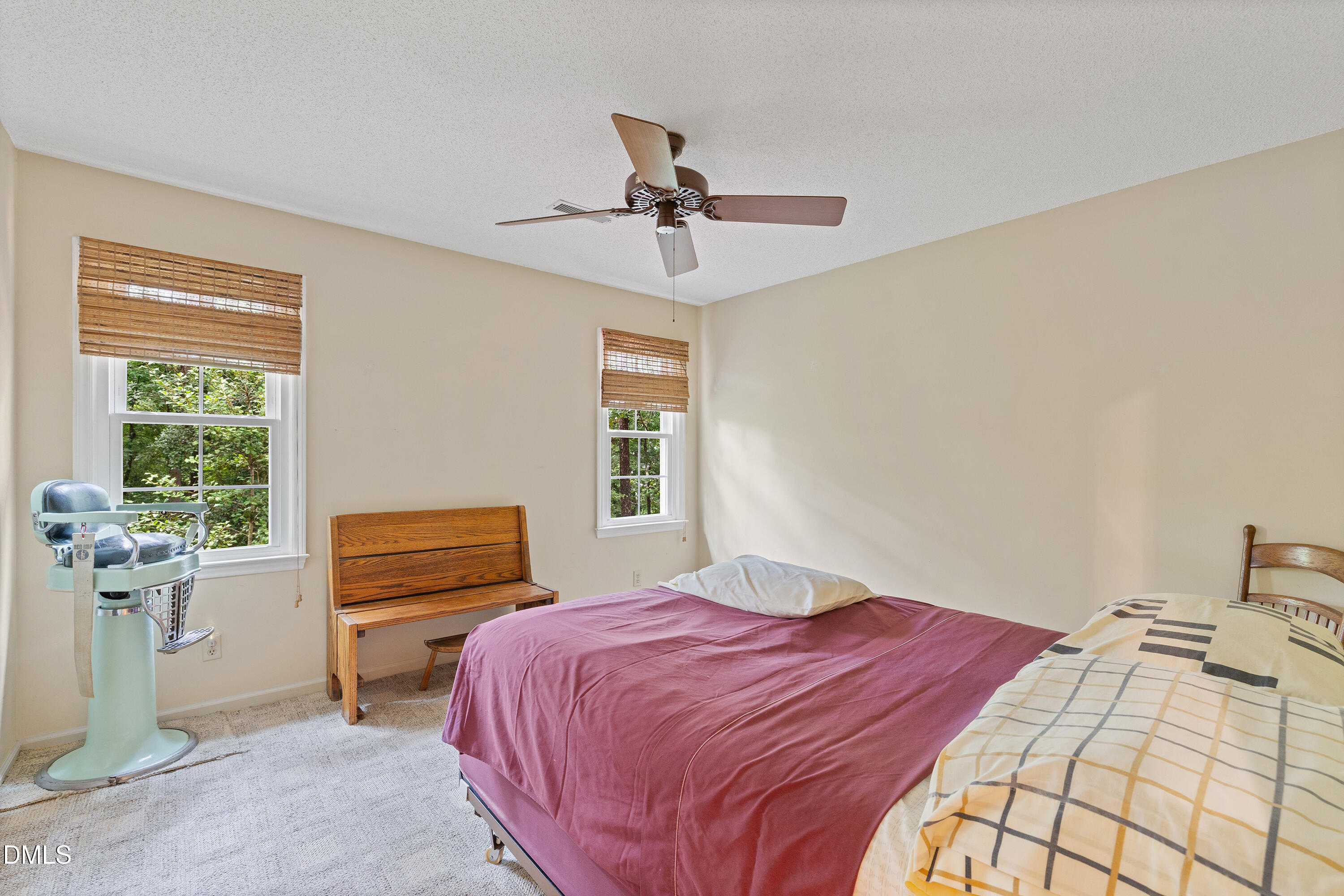 5216 Bridget Drive Raleigh, NC 27603 - Photo 18 of 30 a bedroom with a bed and a chandelier