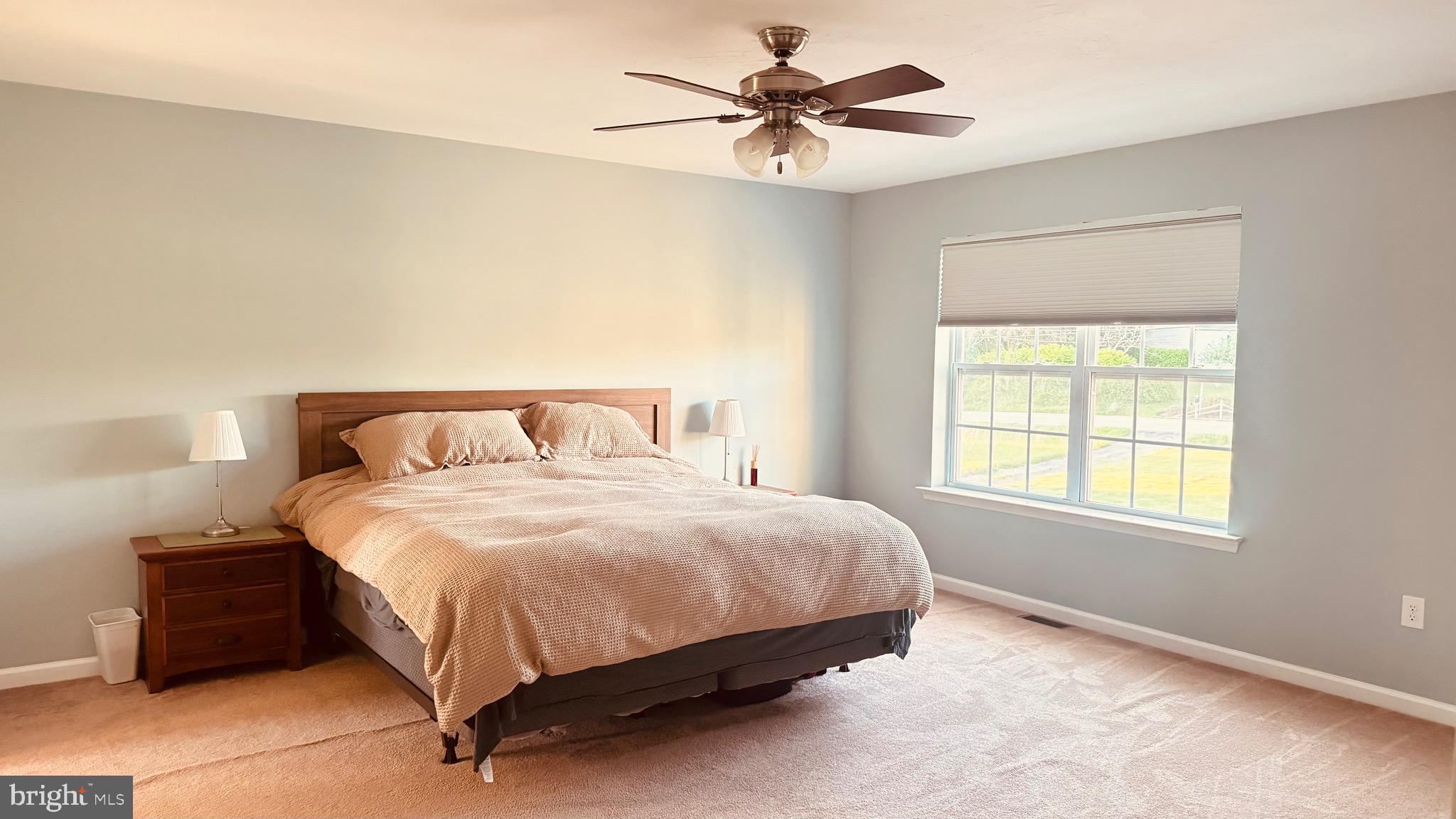 2295 Harney Road Littlestown, PA 17340 - Photo 28 of 37 a bedroom with a bed chandelier and a window