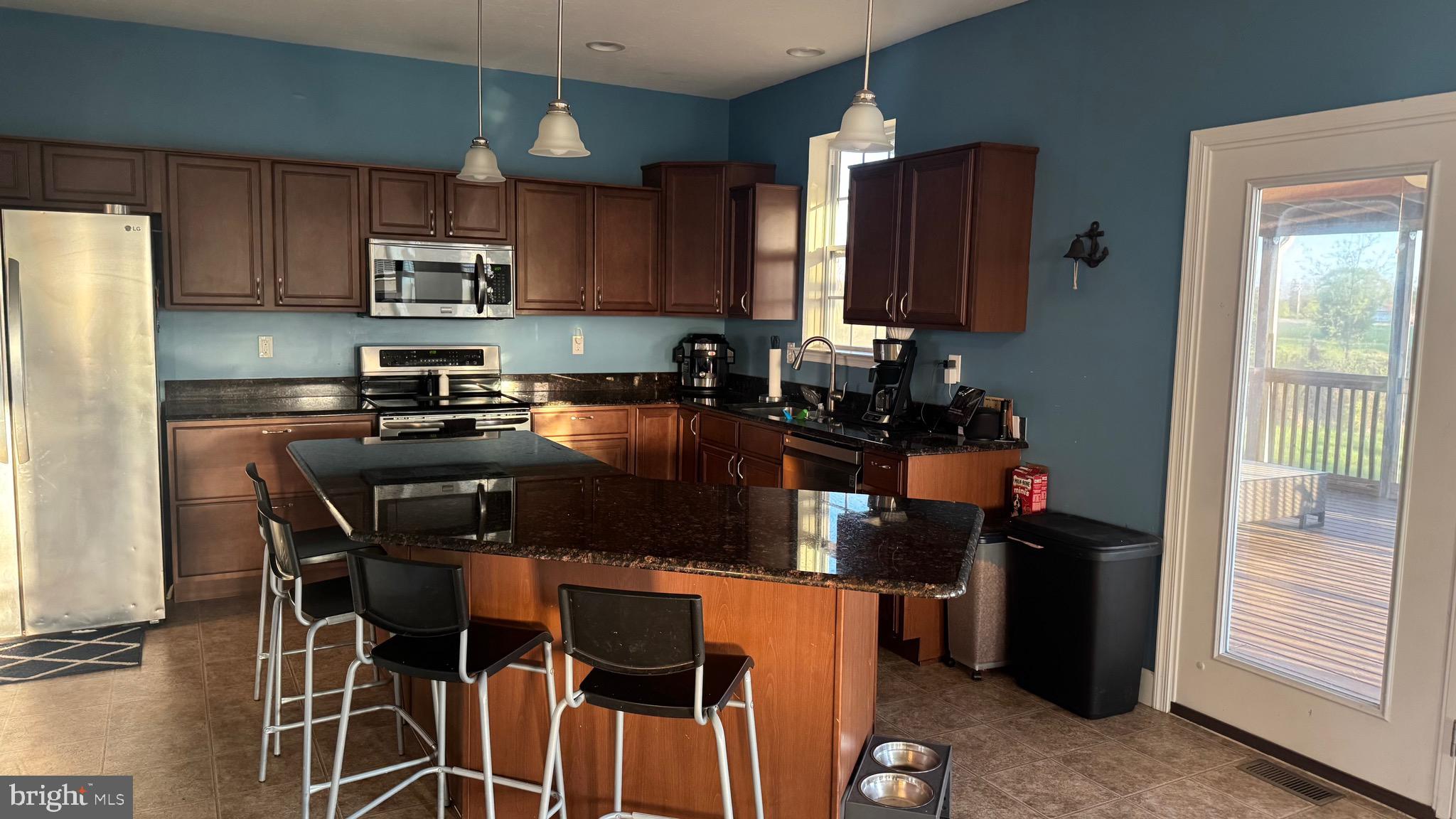 2295 Harney Road Littlestown, PA 17340 - Photo 30 of 37 a kitchen with a table chairs refrigerator and microwave