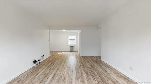 a view of a room with wooden floor and window