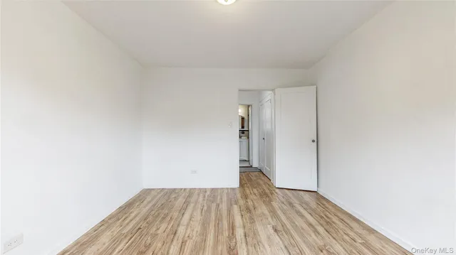 a view of a room with wooden floor